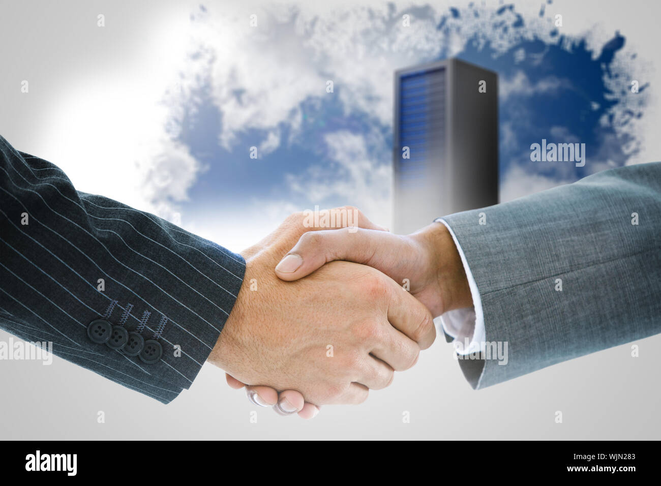 Composite image of business handshake against keyhole on technological black background Stock Photo