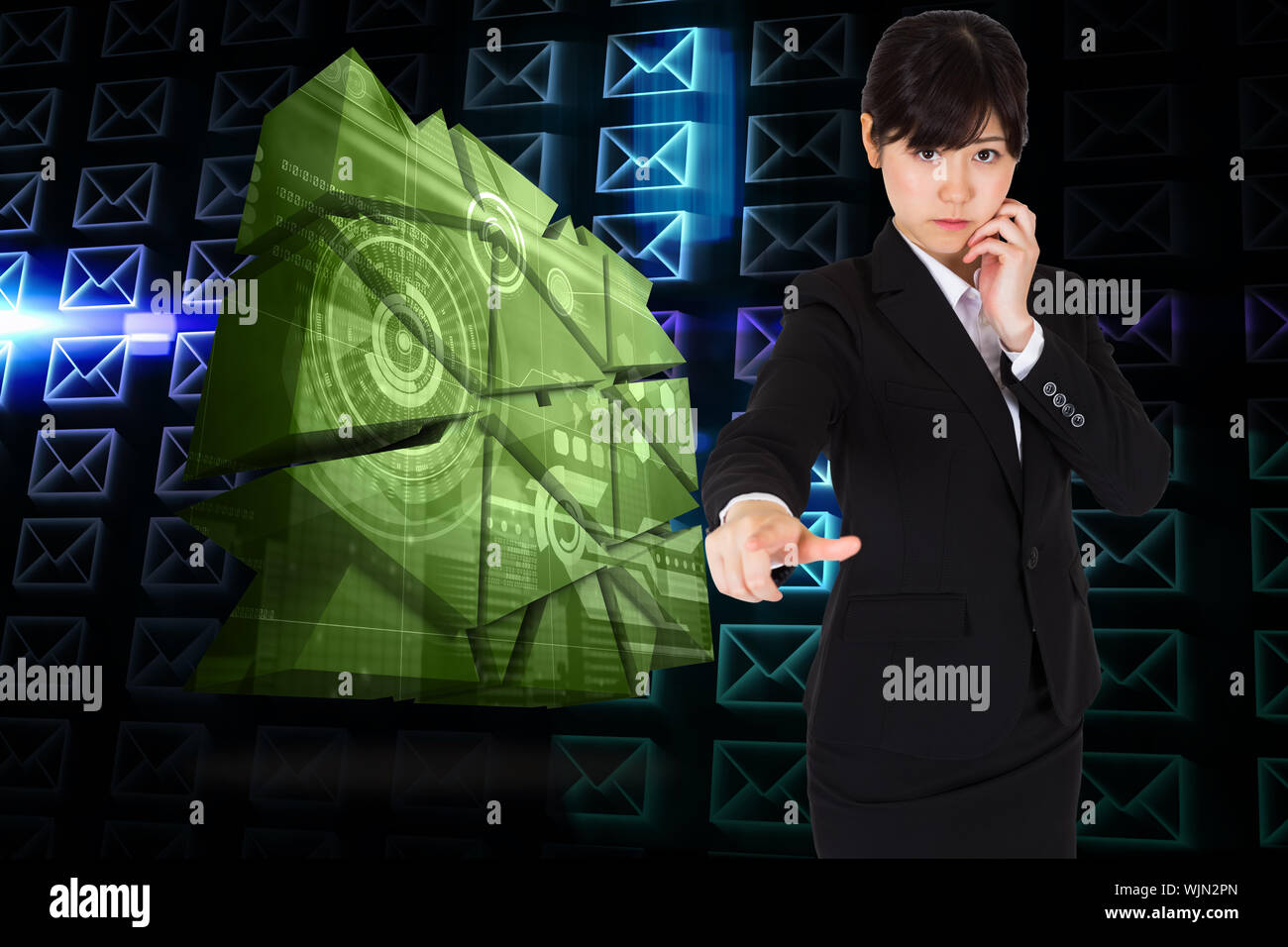 Thoughtful businesswoman pointing against glowing envelopes on black background Stock Photo