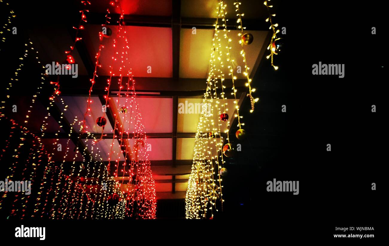 Low Angle View Of Illuminated Christmas Lights Hanging From