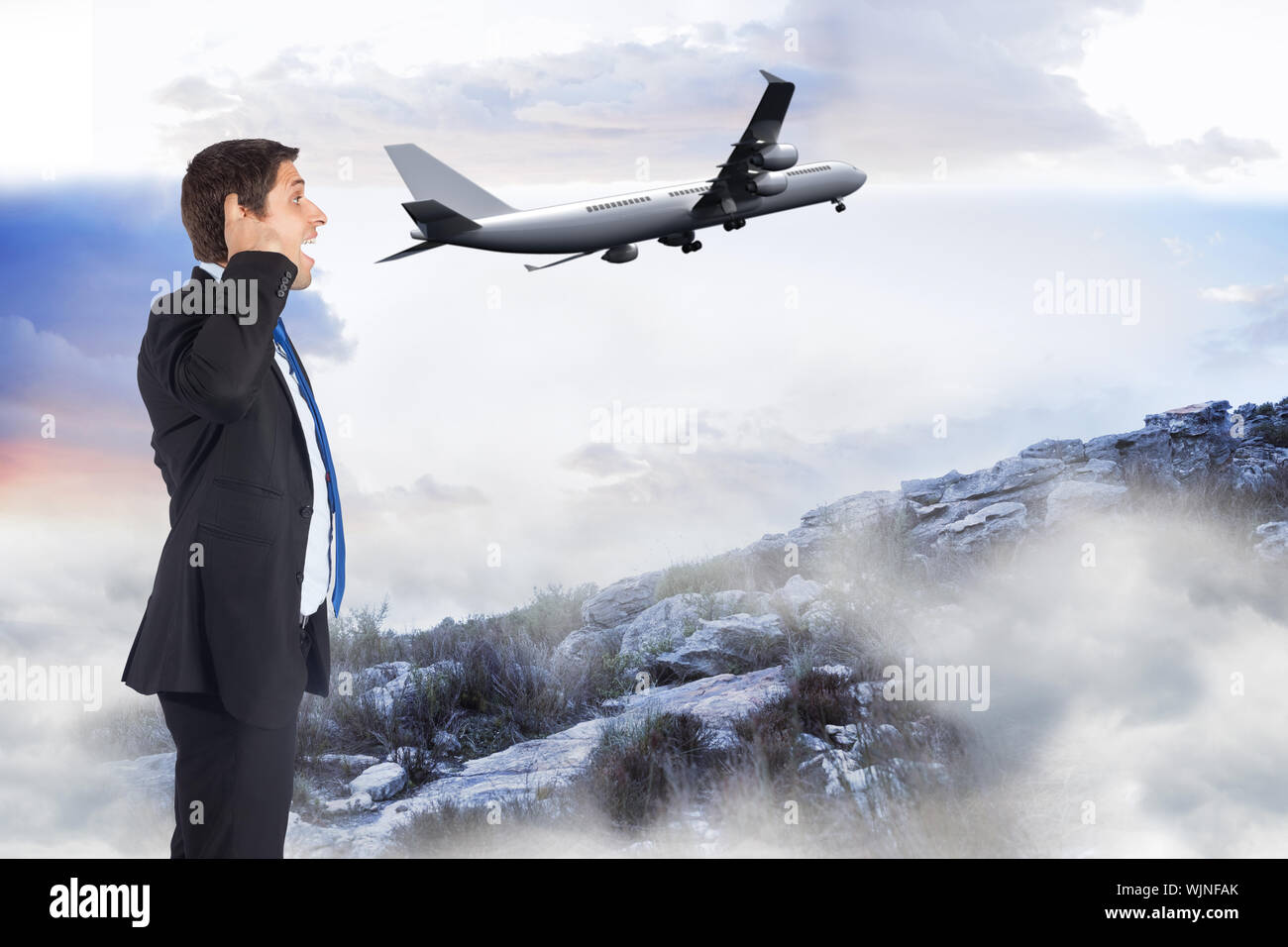Thinking businessman scratching head against misty landscape Stock Photo