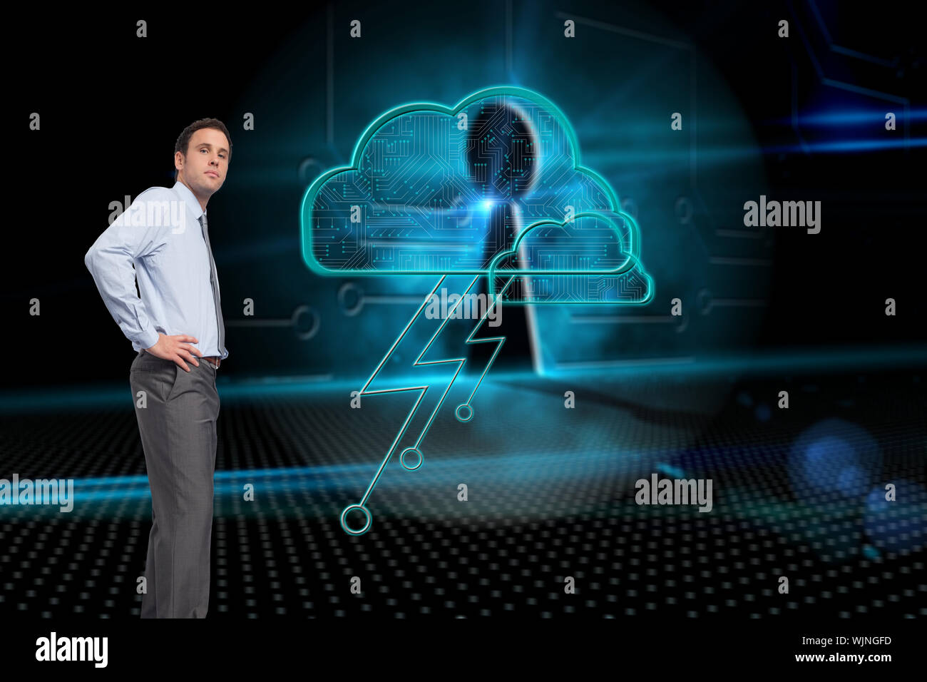 Serious businessman with hand on hip against keyhole on technological background Stock Photo