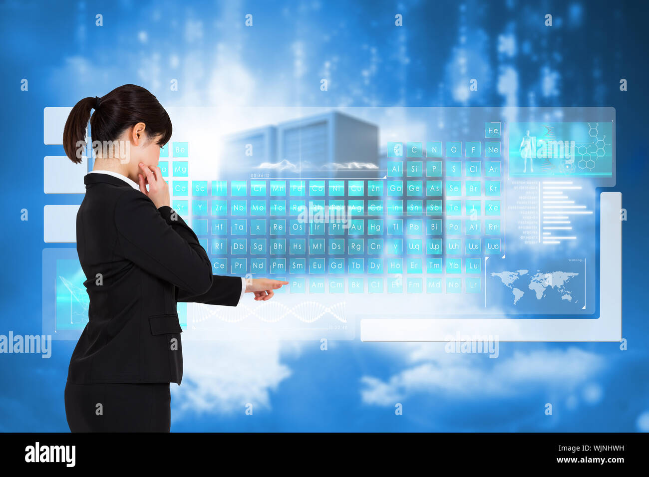 Businesswoman pointing against cityscape on cloud Stock Photo