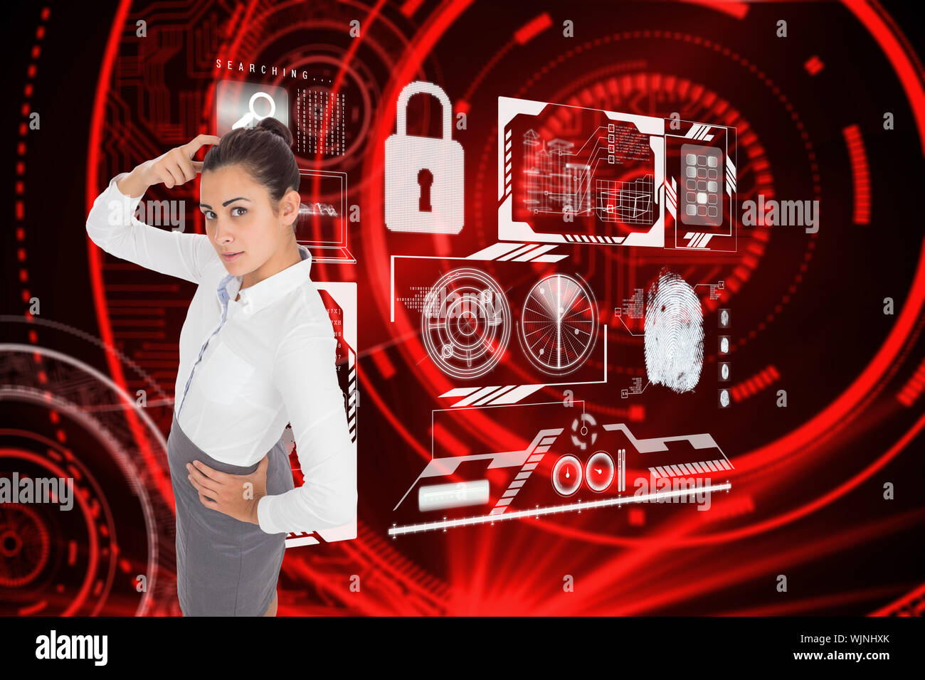 Focused businesswoman against shiny red circles on black background Stock Photo