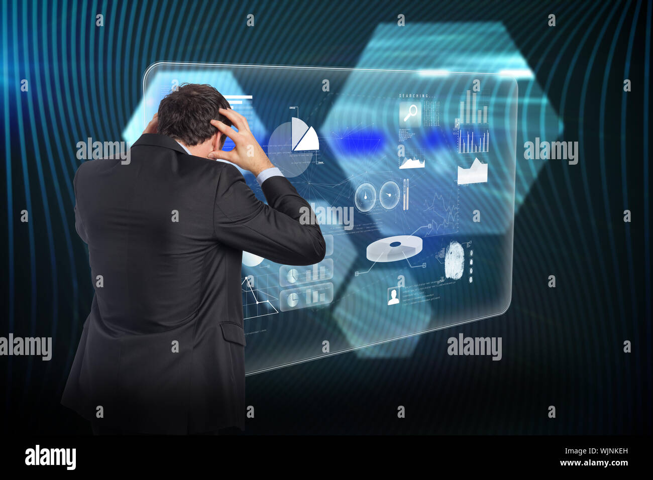 Stressed businessman with hands on head against shiny hexagons on black background Stock Photo