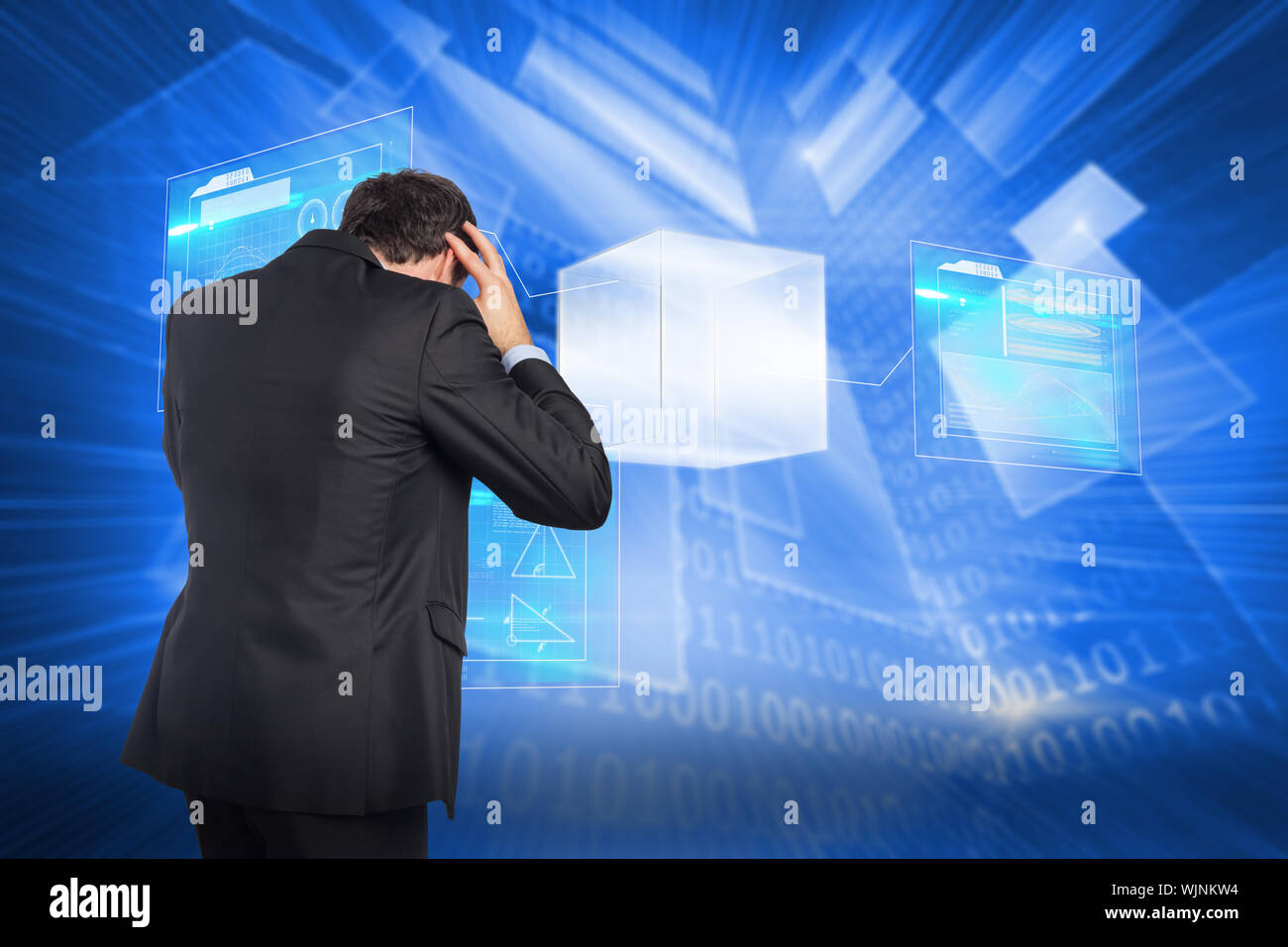 Stressed businessman with hands on head against shiny technological background Stock Photo
