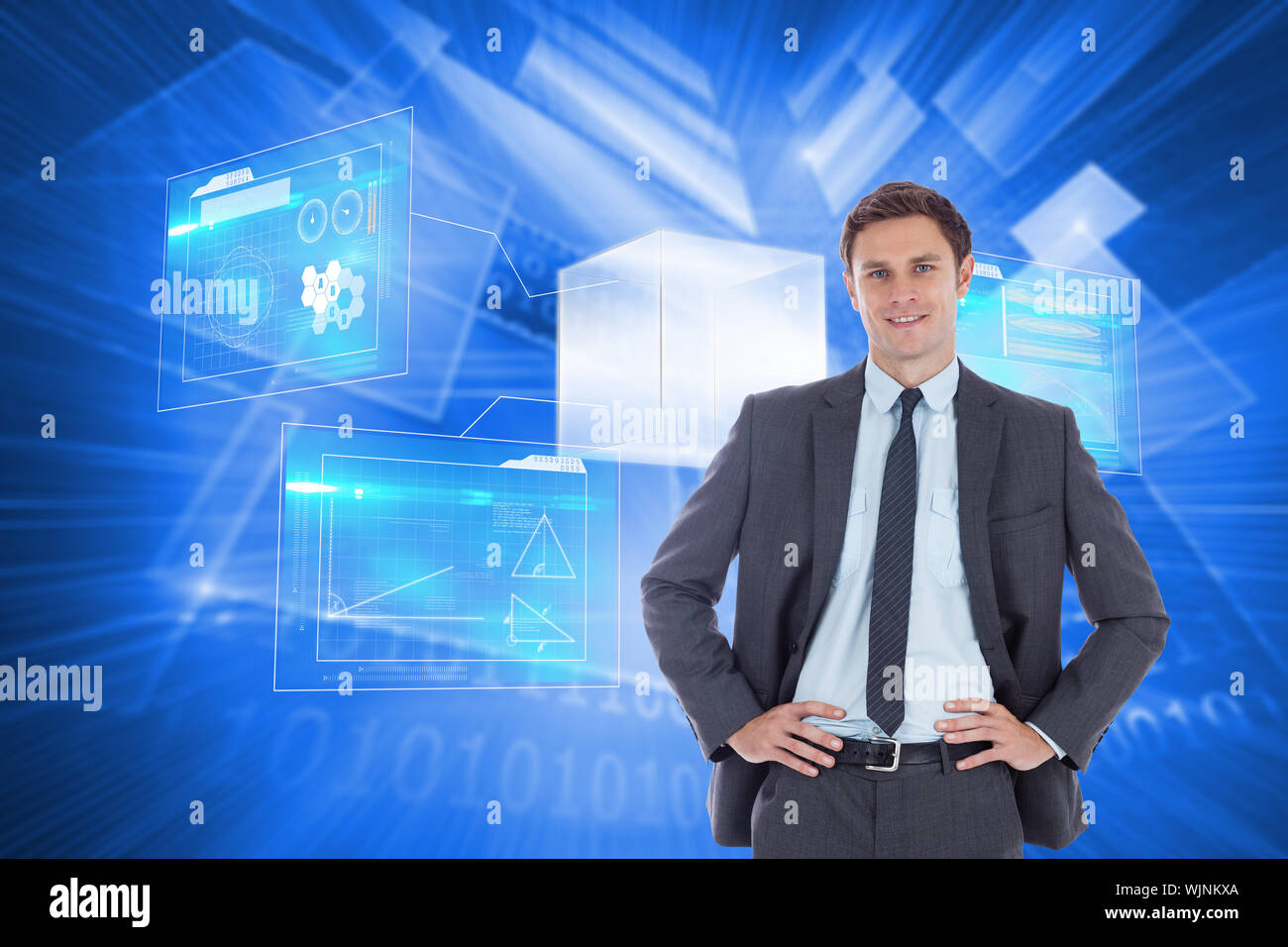 Smiling businessman with hands on hips against shiny technological background Stock Photo