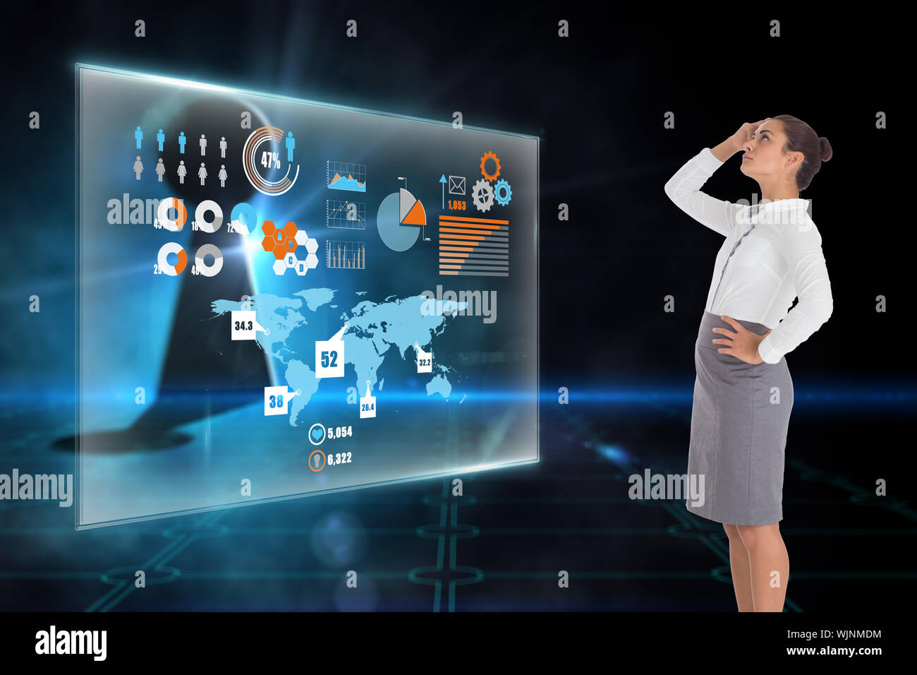 Focused businesswoman against keyhole on technological black background Stock Photo