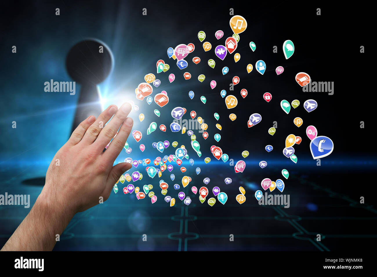 Hand presenting against keyhole on technological black background Stock Photo