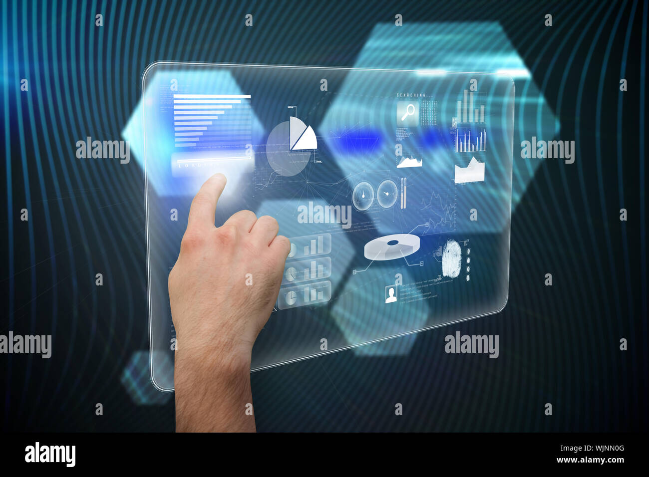 Hand pointing against shiny hexagons on black background Stock Photo