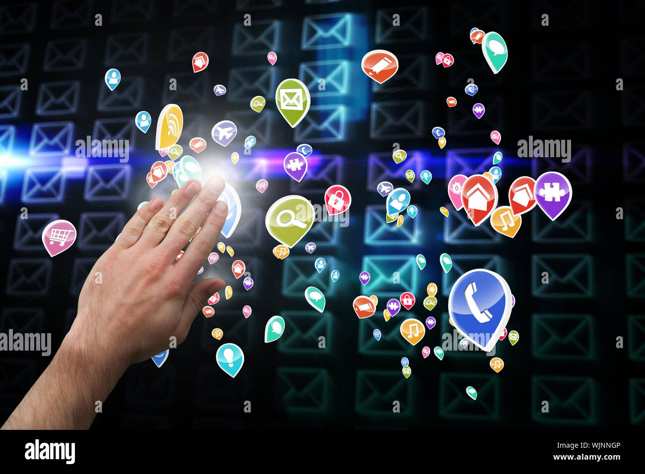 Hand presenting against glowing envelopes on black background Stock Photo