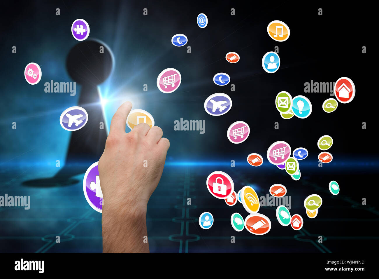 Hand pointing against keyhole on technological black background Stock Photo