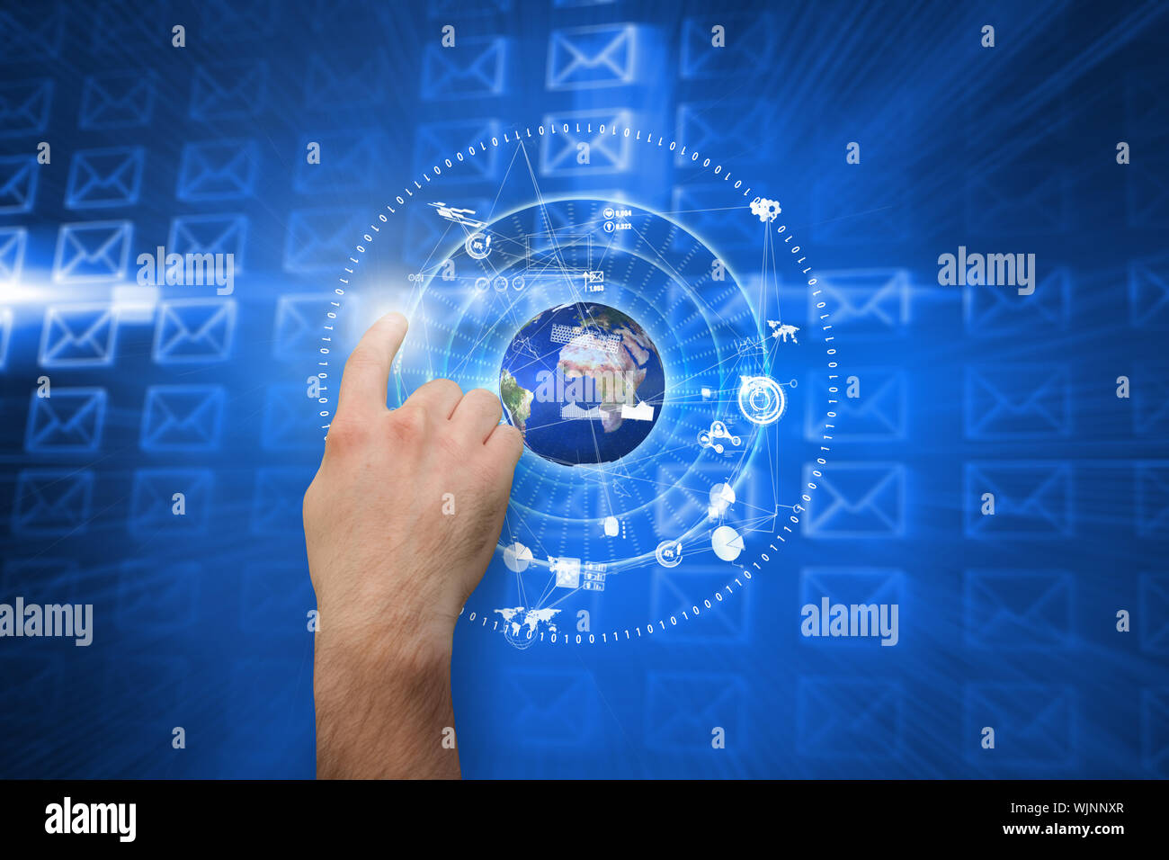 Hand pointing against glowing envelopes on blue background Stock Photo