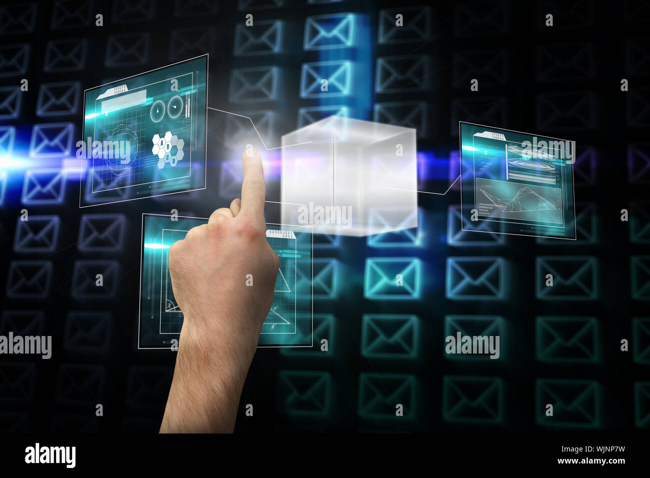 Hand pointing against glowing envelopes on black background Stock Photo