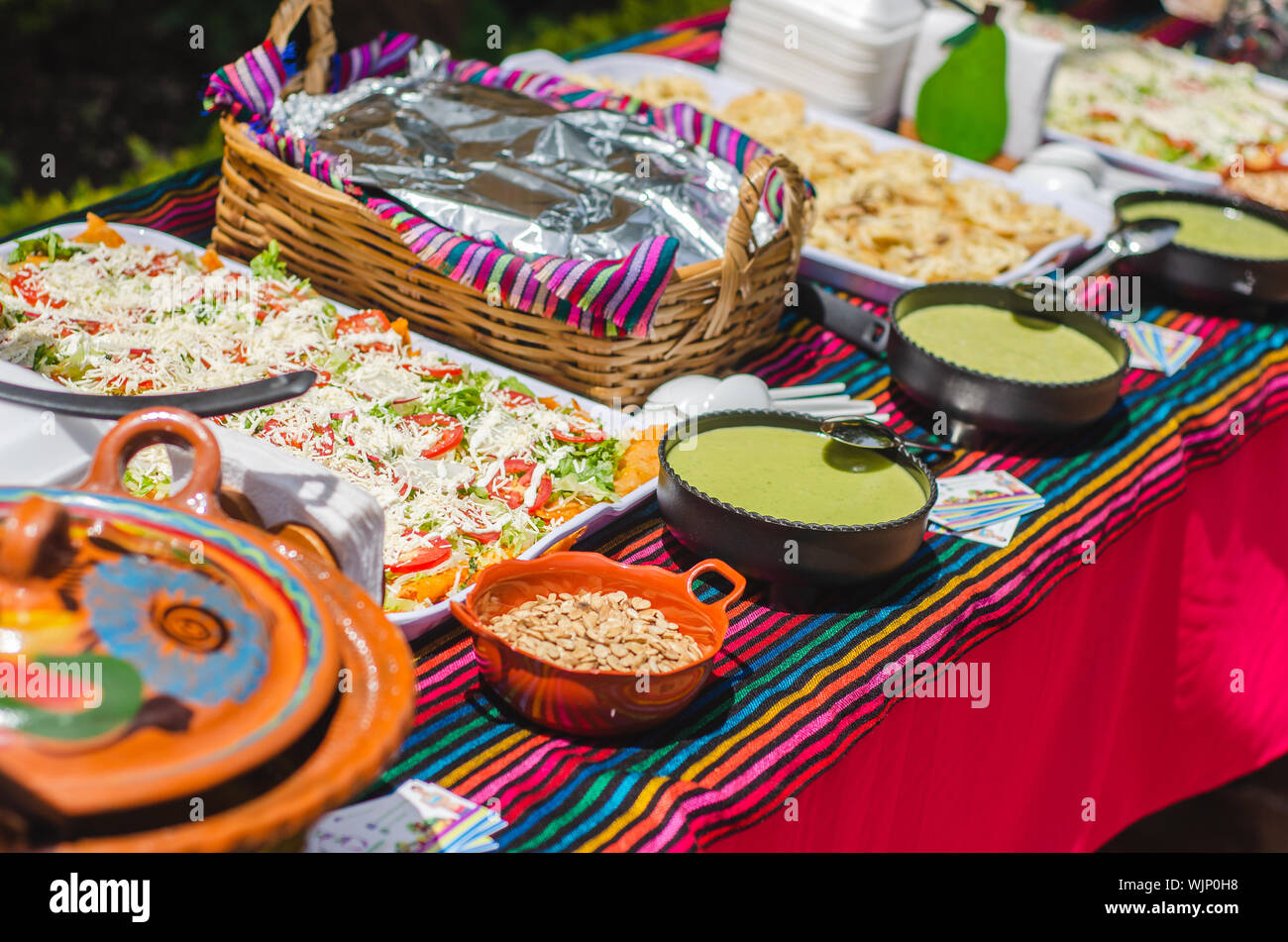 Table of Mexican Buffet with tacos enchiladas chalupas and tamales on a