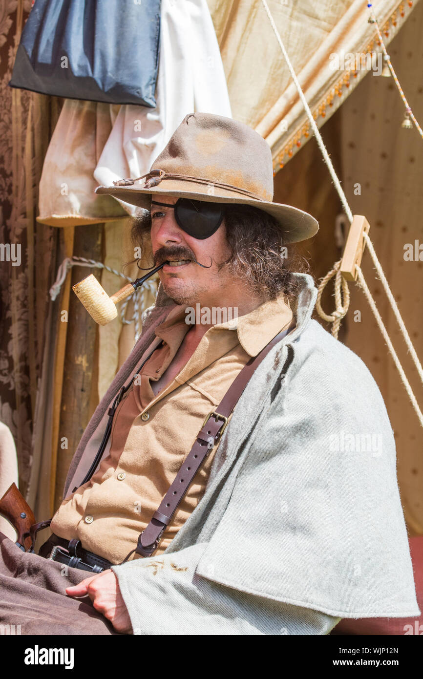 Confederate soldiers smoking a pipe at an  encampment during an American Civil War reenactment in Central Park Huntington Beach, California, USA. Stock Photo