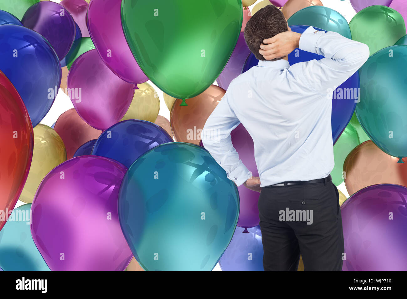 Thinking businessman scratching head against colourful balloons Stock Photo