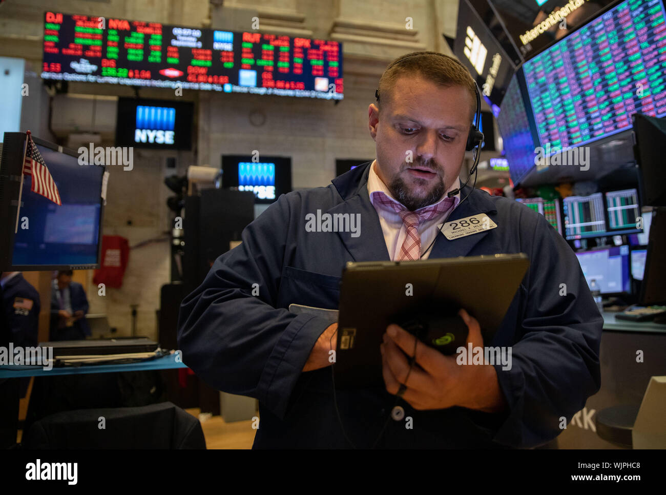 New York, USA. 3rd Sep, 2019. A trader works at the New York Stock Exchange in New York, the United States, on Sept. 3, 2019. U.S. stocks closed lower on Tuesday. The Dow Jones Industrial Average fell 285.26 points, or 1.08 percent, to 26,118.02. The S&P 500 was down 20.19 points, or 0.69 percent, to 2,906.27. The Nasdaq Composite Index fell 88.72 points, or 1.11 percent, to 7,874.16. Credit: Guo Peiran/Xinhua/Alamy Live News Stock Photo