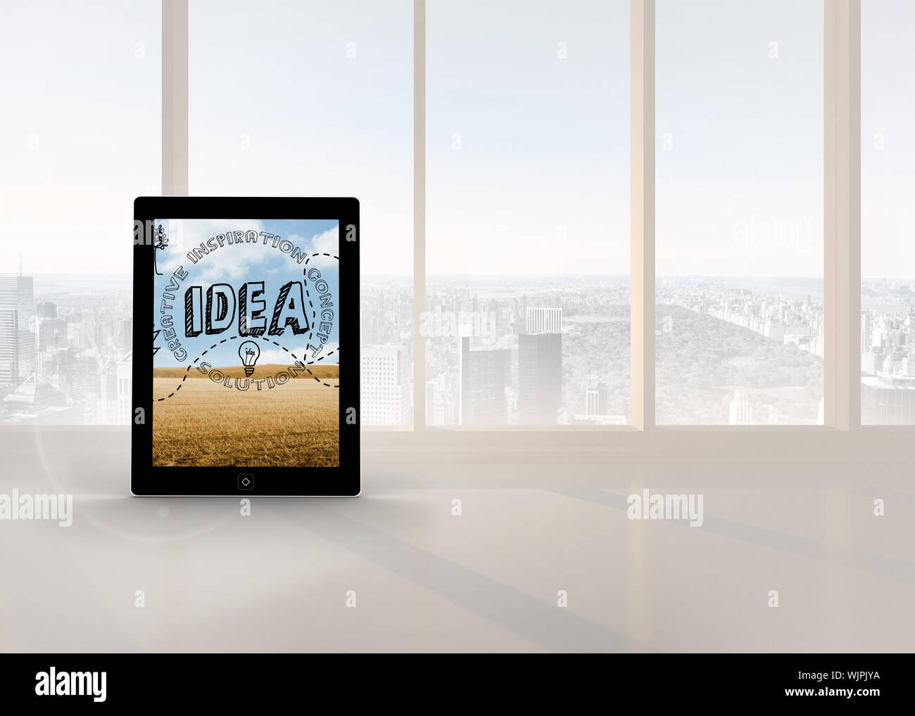 Idea graphic on tablet screen against bright white room with windows