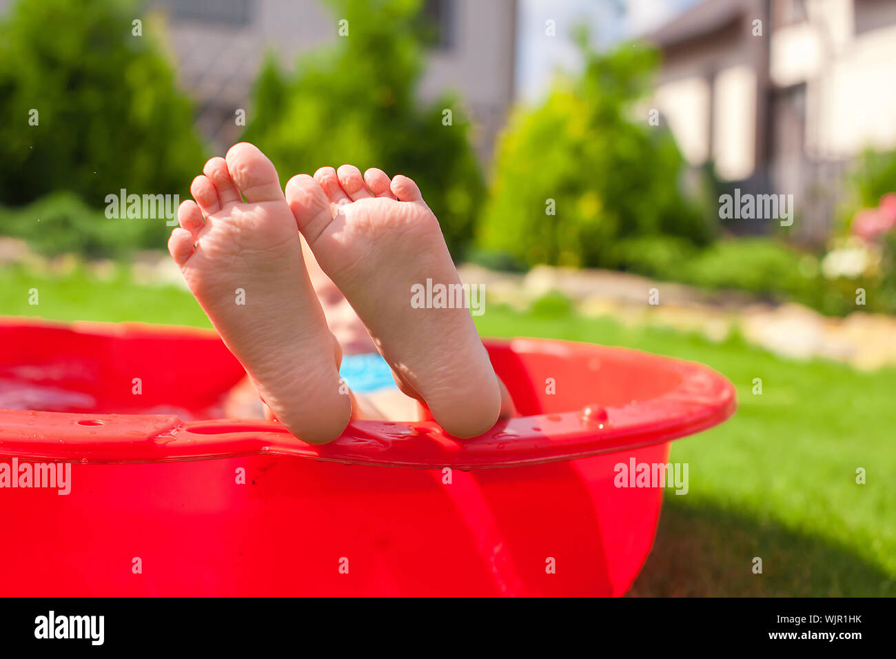 closeup-of-little-kid-s-legs-in-small-red-pool-stock-photo-alamy