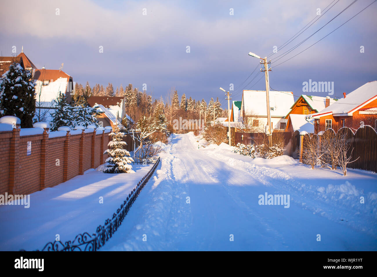 Winter snowy landscape with houses in a small village Stock Photo - Alamy