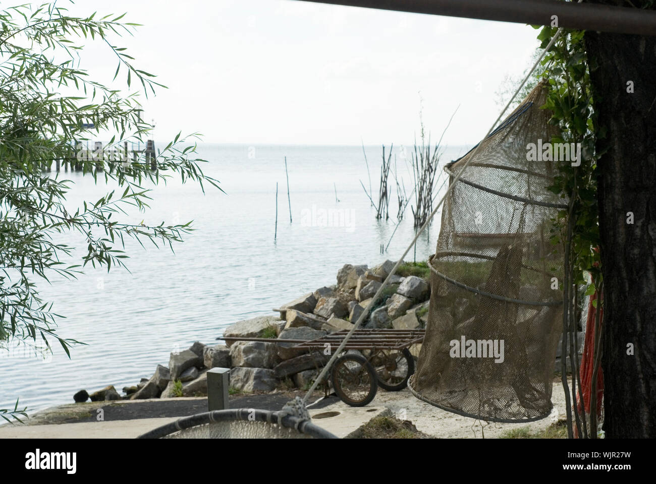 fishing-nets from fisherman drying near the lake Stock Photo