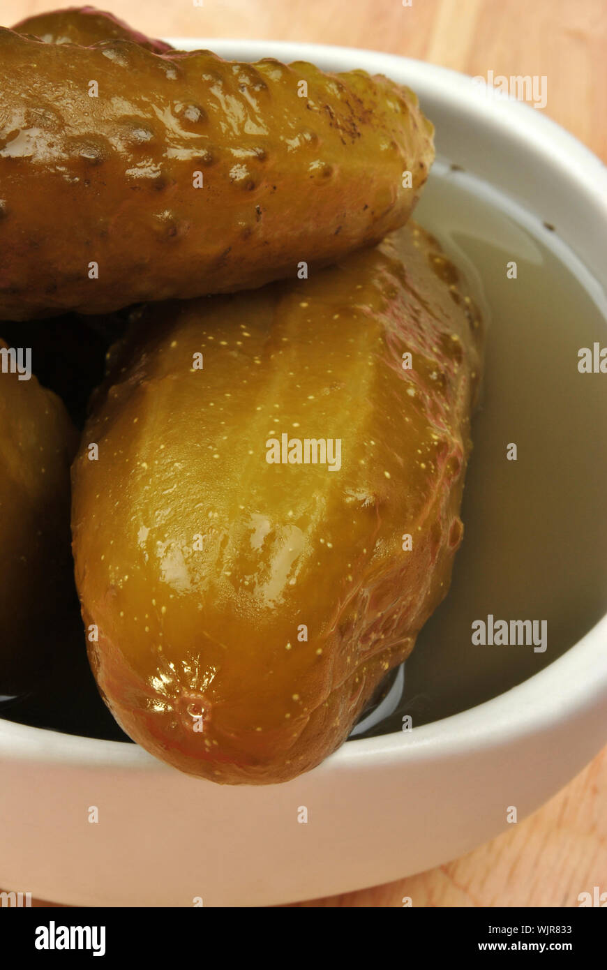 organic pickled gherkin in a white bowl Stock Photo Alamy