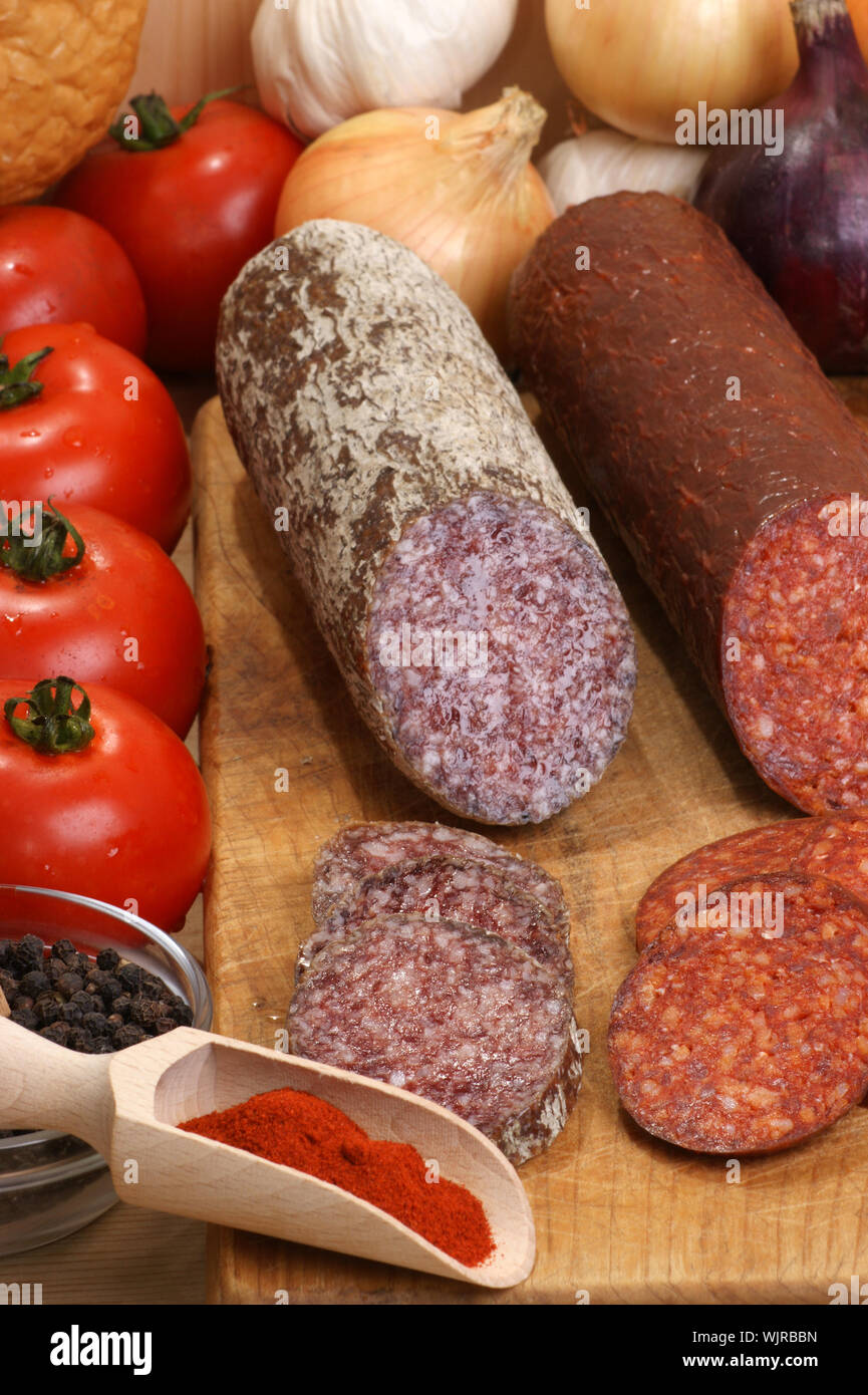 salami and some slices salami on a timber board Stock Photo - Alamy