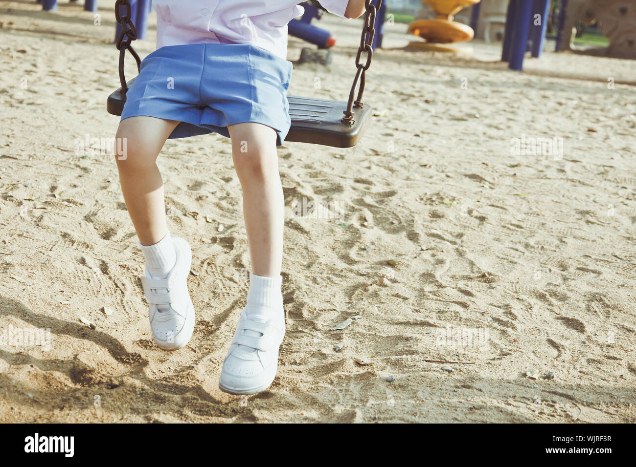 Little child on a swing in the park. Stock Photo