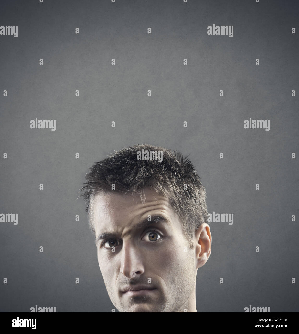 Facial expression: doubt and suspiciousness. copy space Stock Photo