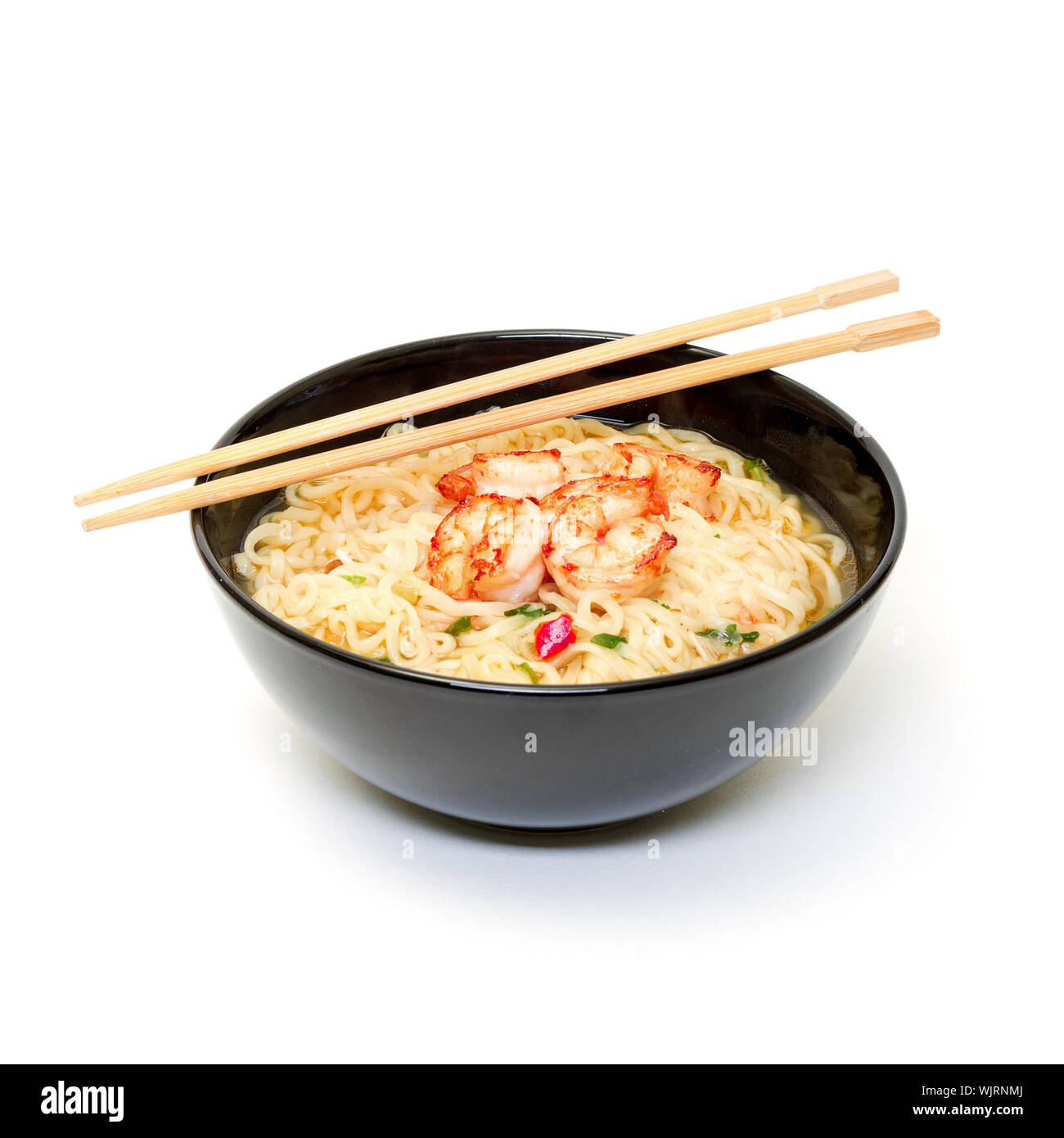 Shrimp and noodle soup bowl with chopsticks on white background Stock