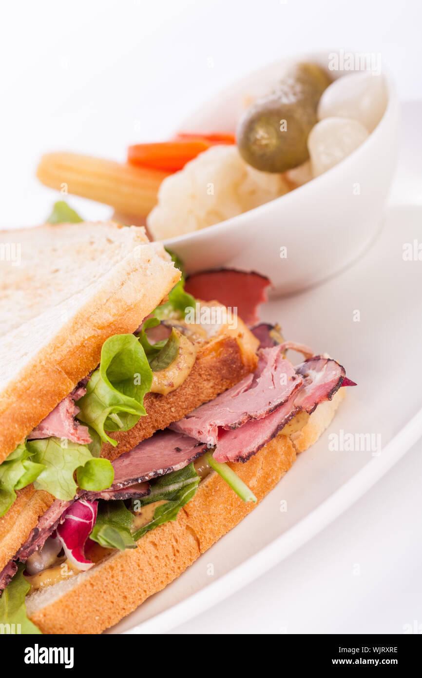 Delicious pastrami club sandwich and pickles Stock Photo Alamy