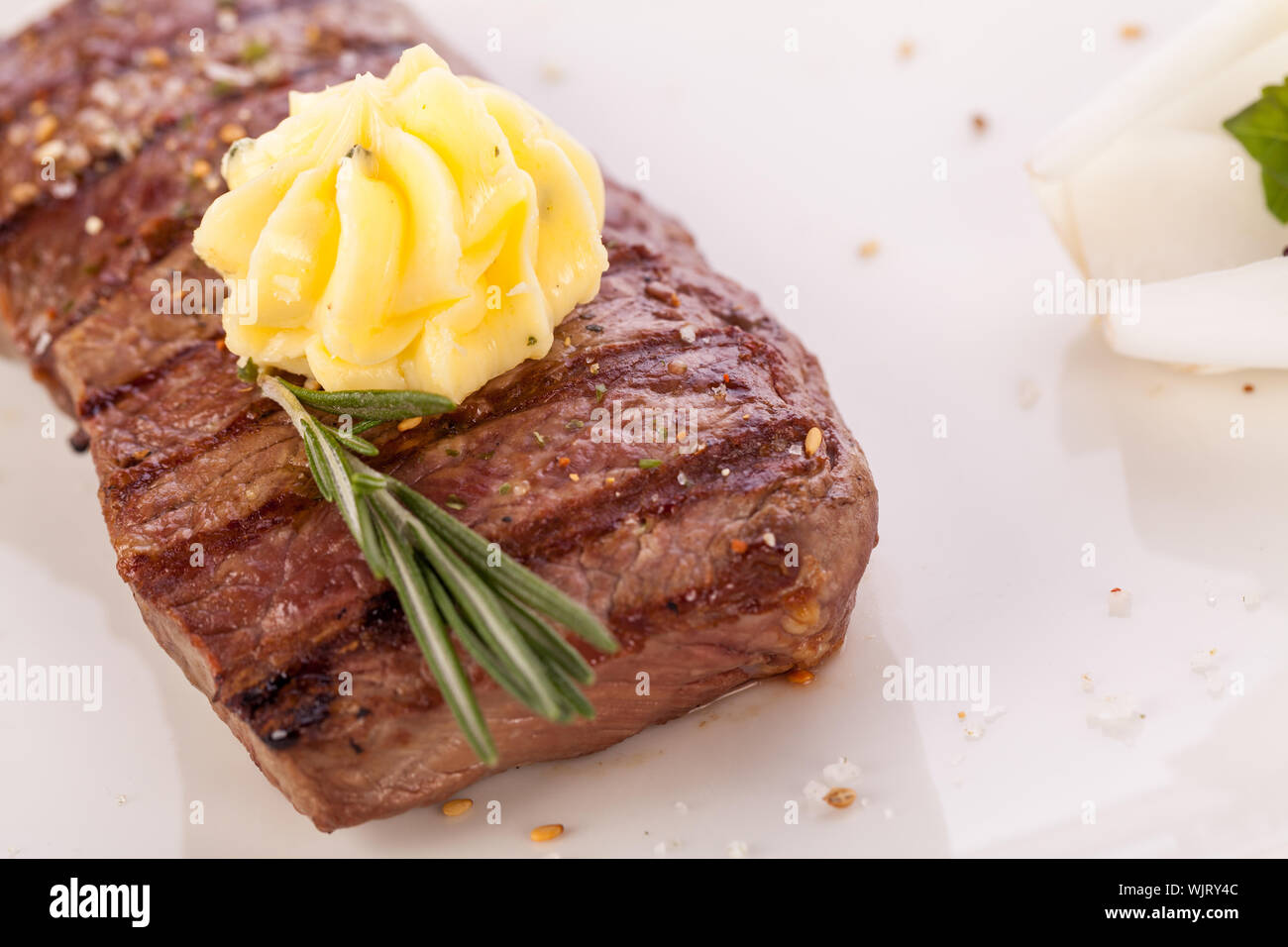 Grilled beef steak topped with butter and rosemary Stock Photo