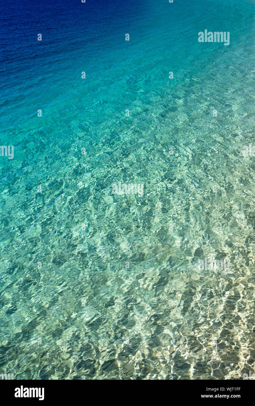 Blue water with sun reflections Stock Photo - Alamy