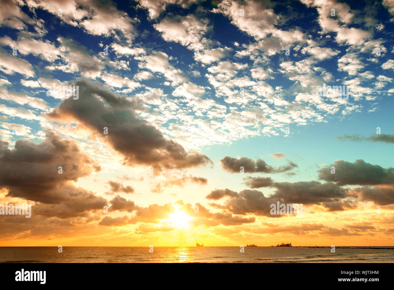 Sunrise with sun rays and clouds Stock Photo - Alamy