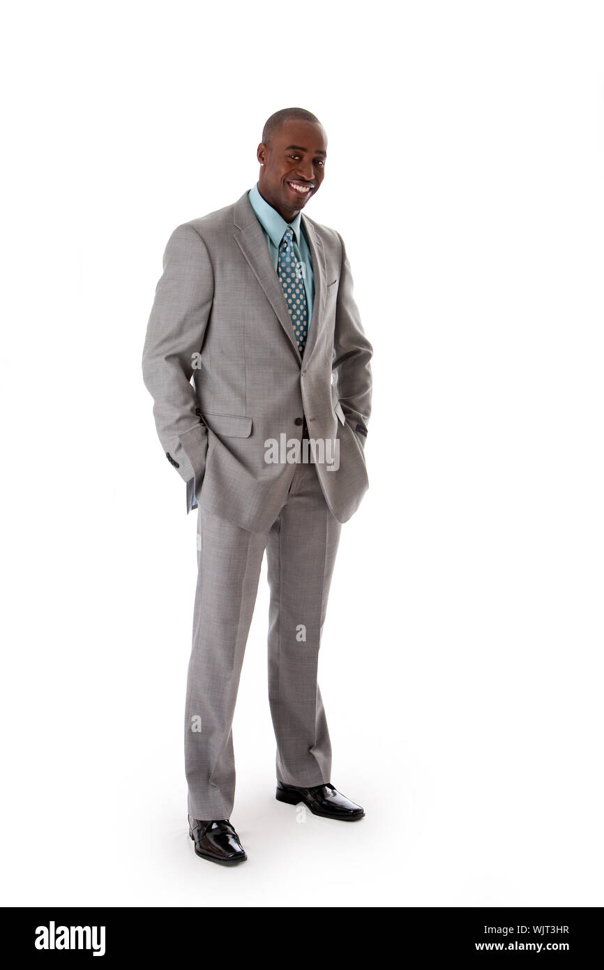 Man in suit hands in pocket smiling hi-res stock photography and