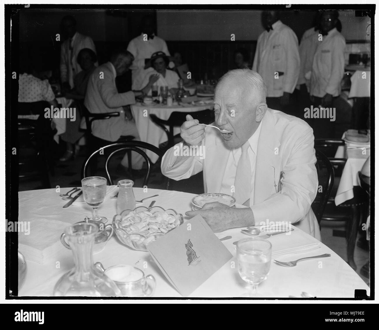 House Minority Leader grabs hurried lunch. Washington D.C. Aug 21. House Minority Leader Bertrabd Snell of New York, hurried his lunch in order not to miss the action on theHouse floor as 75th Congress prepares to adjourn Stock Photo
