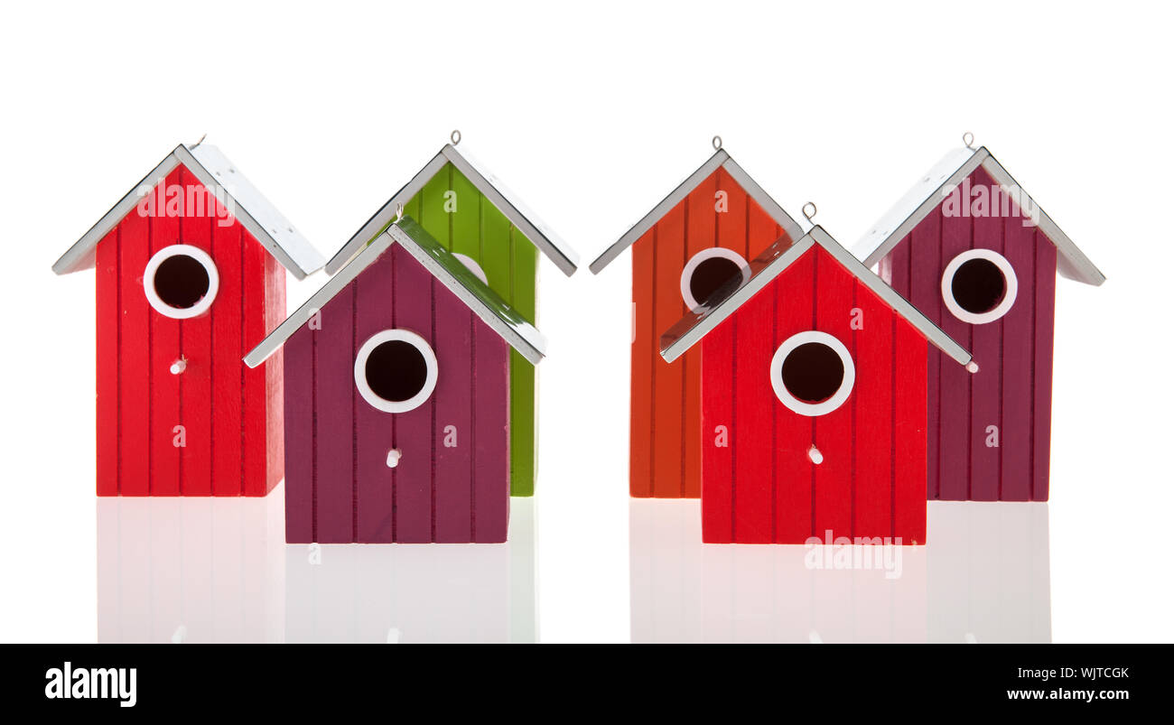 Colorful bird houses in a row isolated over white background Stock