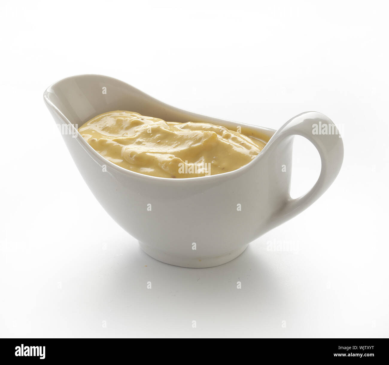 Yellow mustard sauce in the white sauceboat Stock Photo Alamy