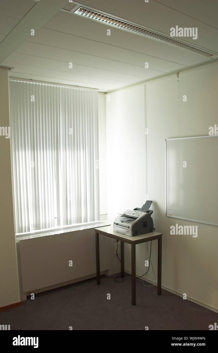 Fax machine standing in an office next to a window Stock Photo - Alamy