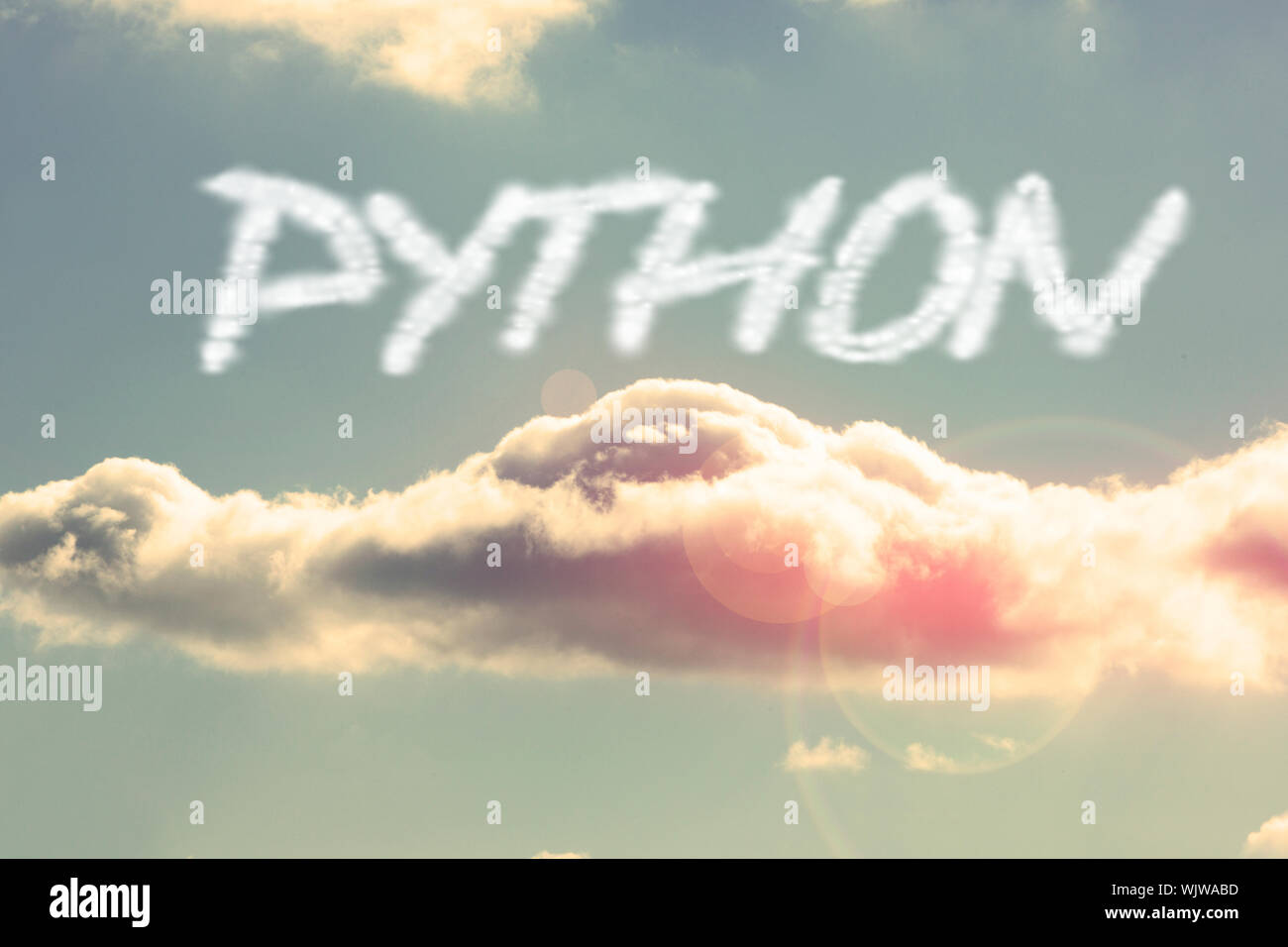 The word python against bright blue sky with cloud Stock Photo - Alamy