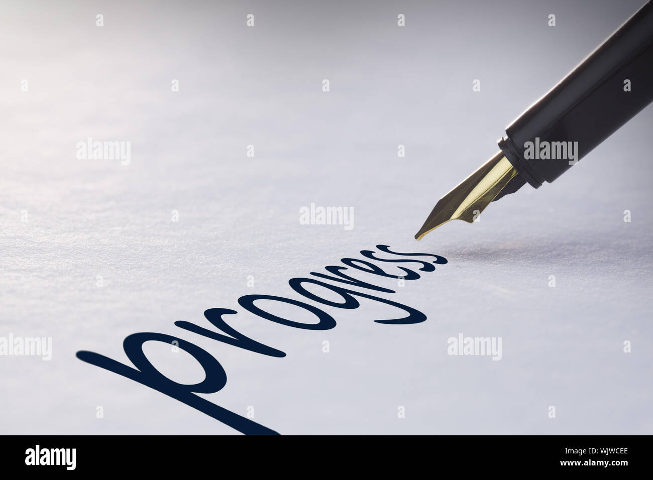 Fountain pen writing the word progress Stock Photo - Alamy