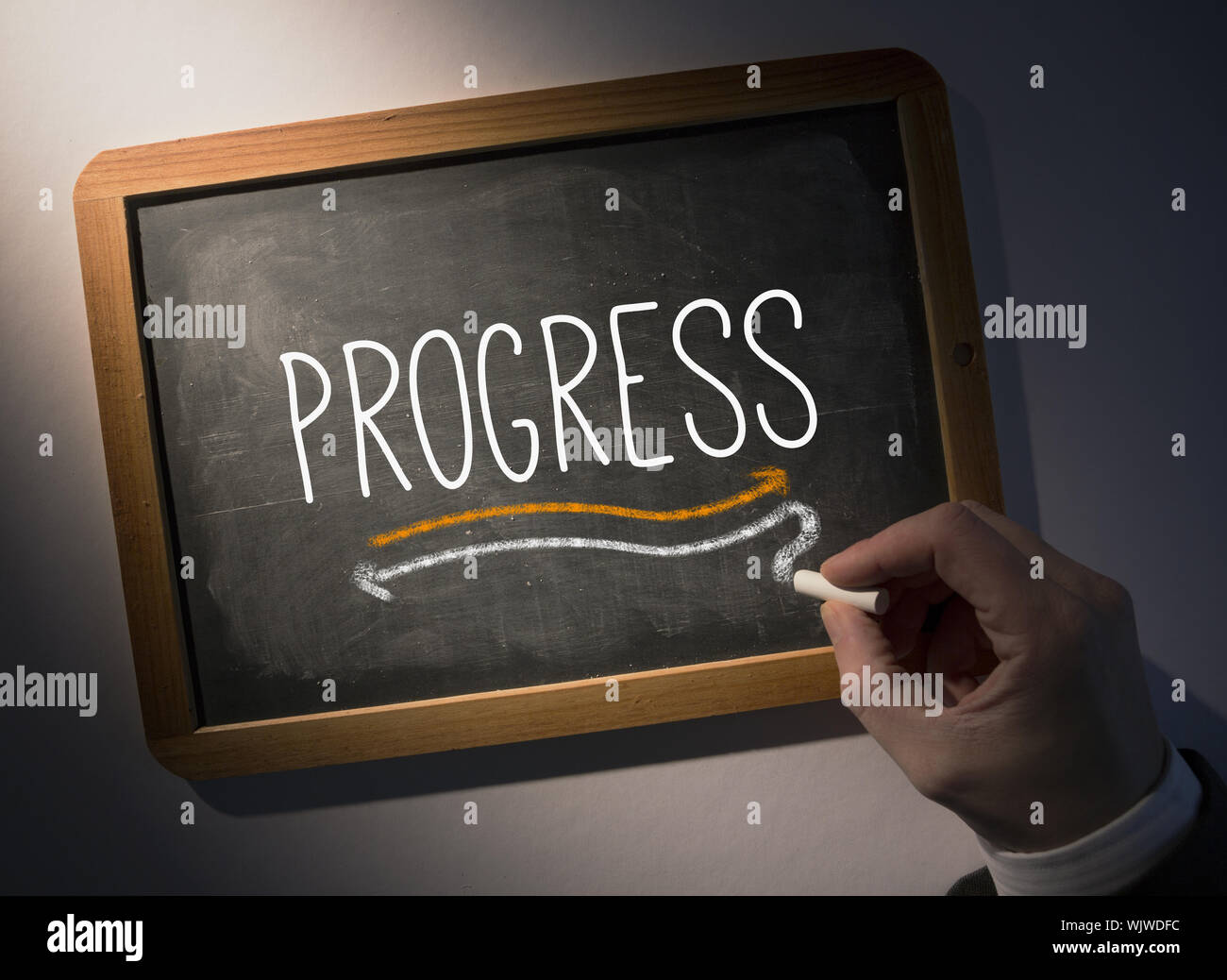 Hand writing the word progress on black chalkboard Stock Photo - Alamy