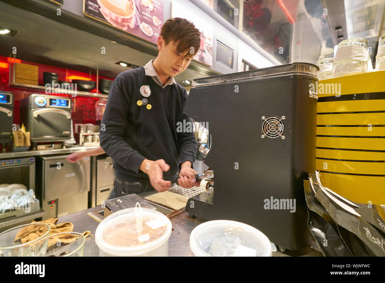 Mccafe Worker HONG KONG, CHINA - CIRCA FEBRUARY, 2019: worker preparing coffee at ...