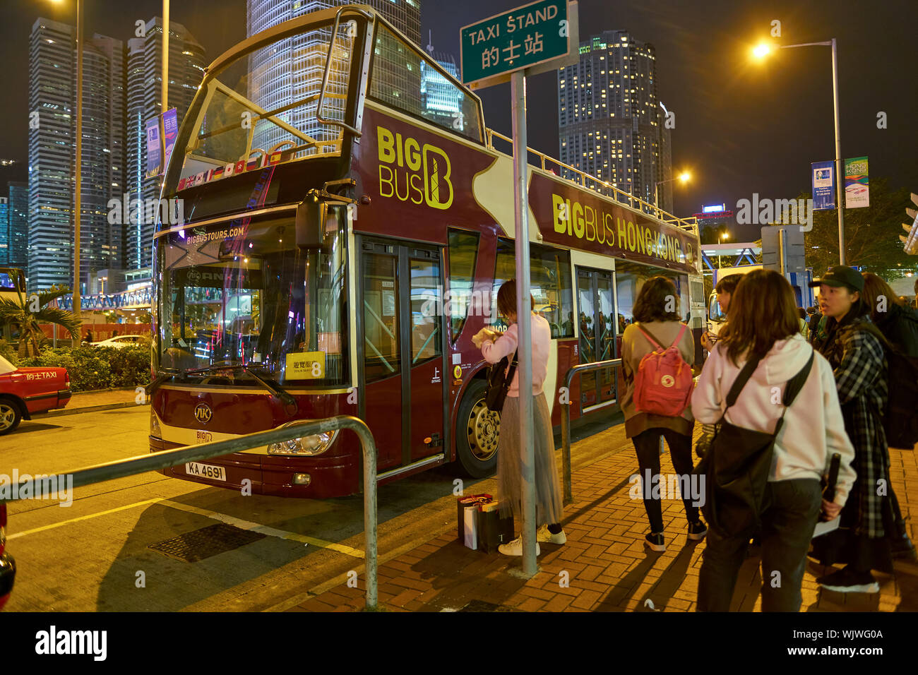 HONG KONG, CHINA - CIRCA JANUARY, 2019: hop-on hop-off double-decker bus in Hong Kong at night. Stock Photo