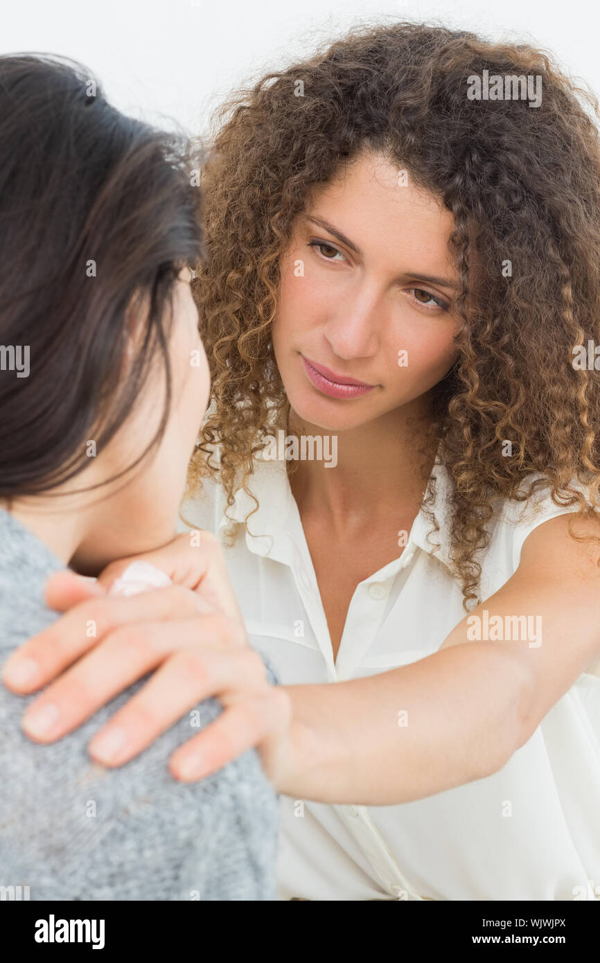 Therapist comforting her crying patient at therapy session Stock Photo