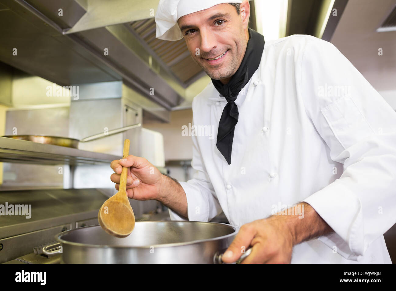 Side view portrait of a male chef preparing food in the kitchen Stock ...