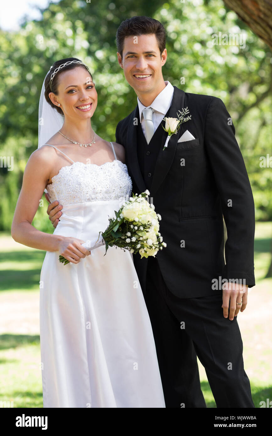 Couple standing arm in wedding hi-res stock photography and images - Alamy