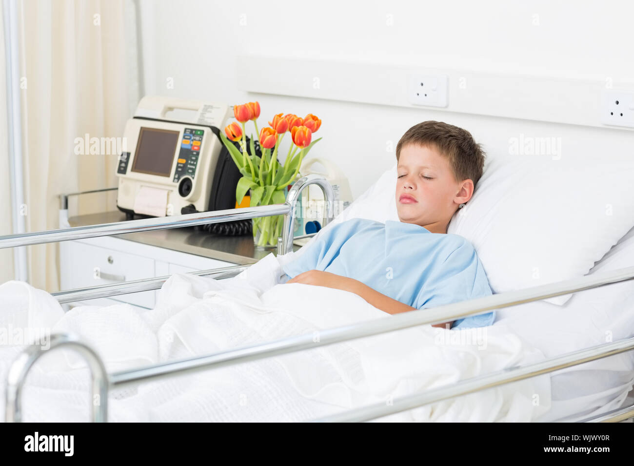 Sick little boy sleeping in hospital ward Stock Photo