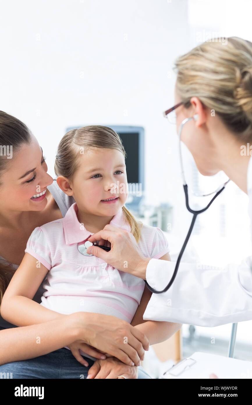 Mother with girl being examined by female doctor in hospital Stock Photo