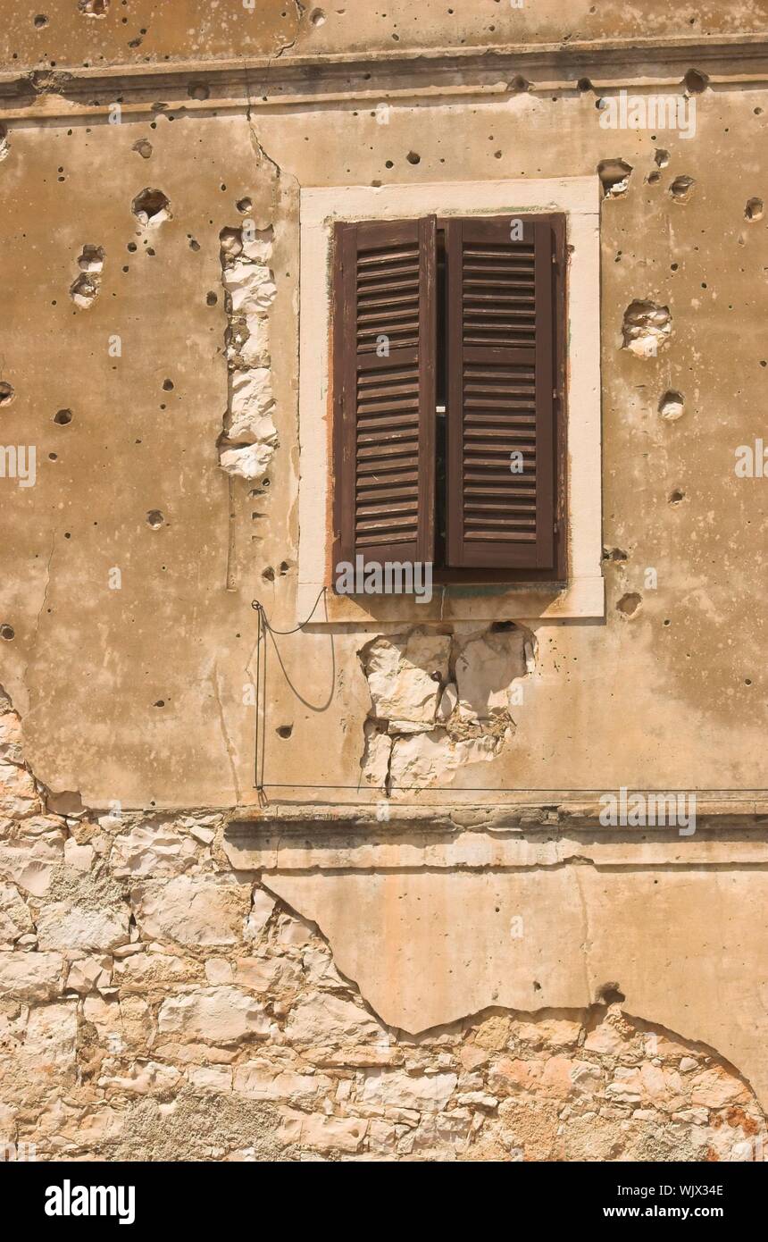 Old building facade in Croatia spotted with bullet holes Stock Photo ...